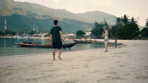 Duo playing on the beach in badminton Stock Footage 94500581