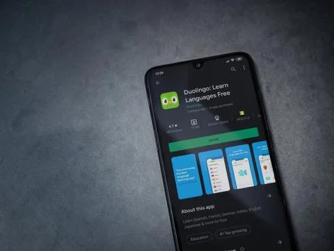 Duolingo - Language learning app play store page on the display of a black mo Stock Photos