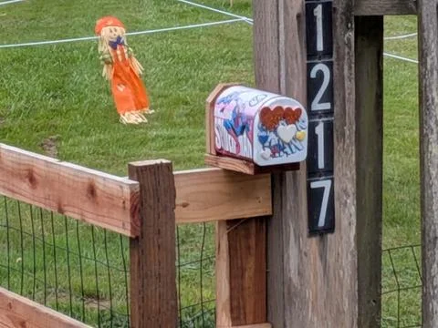 Duplicate view of a miniature mailbox painted with roses Stock Photos