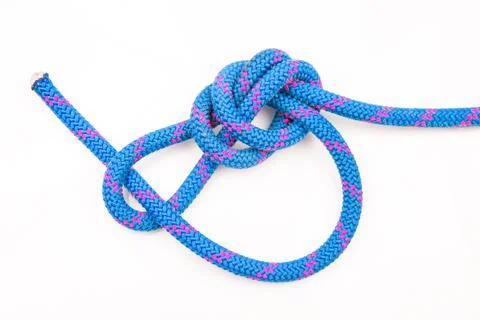 Durable colored rope for climbing equipment on a white background. knot of br Stock Photos