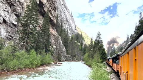 Durango to Silverton Colorado train along river with trees Видео 211791707
