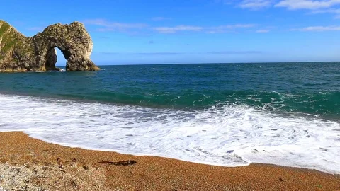 Durdle door and the big waves, filmed from the beach, Dorset, England Stock Footage 125641826
