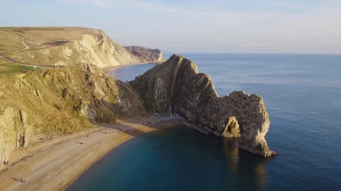 Durdle Door approach shot at sunset with Inspire 2 drone Stock Footage 100883593