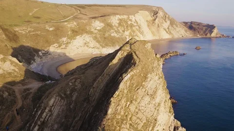 Durdle Door orbit and around cliffs at sunset with inspire 2 drone  Stock Footage 100888969