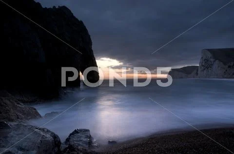 Durdle door in sunset Stock Photos