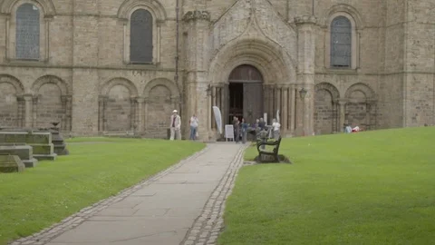 DURHAM CATHEDRAL Tilt up pathway to find doorway. 4K Stock Footage 77609903