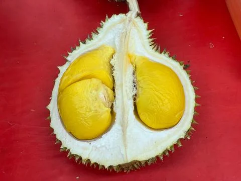 Durian Fruit Opened with Three Chambers on Red Table – Macro Overhead Flat Lay Stock Photos