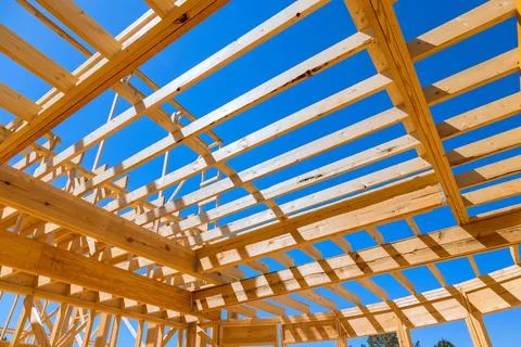 During construction of a new home, ceiling roof trusses framework beams rafters Stock Photos