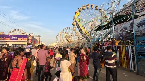 During the day people are queuing up to sit on the rides at the amusement Stock Footage 253841033