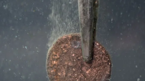 During electrolytic cleaning, bubbles rise from an ancient coin to the top of Video stock 321352391