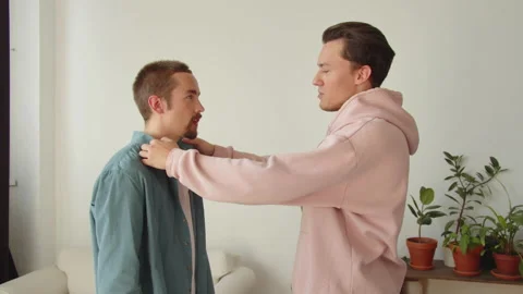 During entertaining conversation, standing together, two young lgbt men are Stock Footage 173818093
