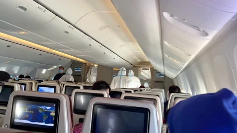 During the flight, the flight attendants were conducting novel COVID-19 Stock Footage 170938483
