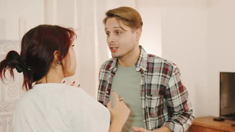 During a heated argument, a husband raises his hand to strike but hesitates Stock Footage 295523914