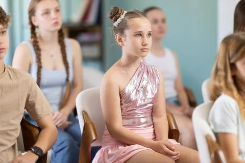 During lecture meeting at class, teens and preteens pupil listen to female Stock Photos