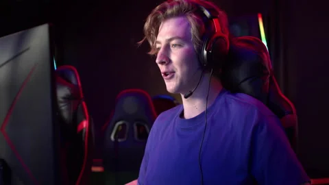 During the online game, a team member actively prompts his teammates and Stock Footage 152799092
