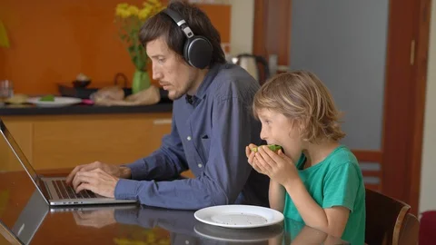 During quarantine, man is trying to work remotely from home, but his son and Stock Footage 128691214