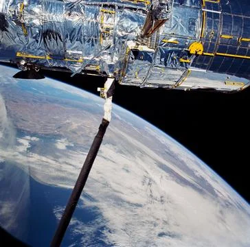 During STS-31, the Hubble Space Telescope (HST) is held in appendage deploy.. Stock Photos