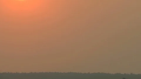 During a sunset the sun changes the color. White, yellow, orange, red. Stockbeeldmateriaal 70216029