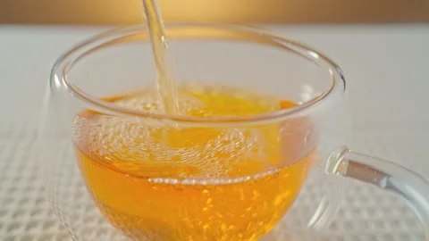 During the tea ceremony, green tea is poured into a glass mug. Stock Footage 295457691
