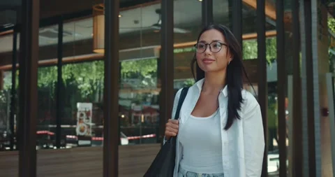 During walk through streets millennial woman feels joy and freedom bright smile Stock Footage 312501920