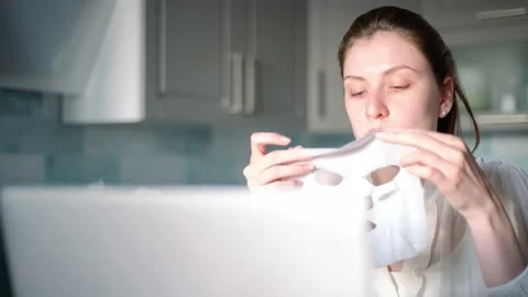 During work, a female freelancer does a spa and applies a moisturizing mask to Stock Footage 130642116