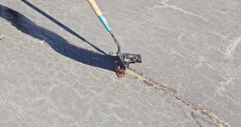 During worker patcher performs coated filling asphalt cracks sealing bitumen Stock Footage 260813145