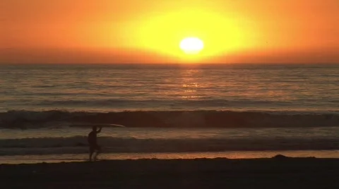 Dusk beach surfer Stock Footage 112620