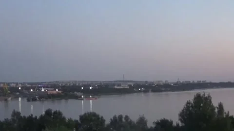 At dusk, a bus crosses a bridge over a river Stock Footage 335705638