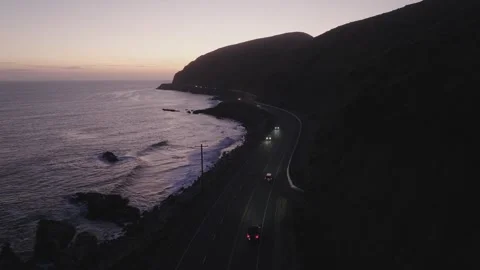 Dusk Car Tracking Winding Oceanside Pacific Coast Highway PCH Aerial Stock Footage 335424527