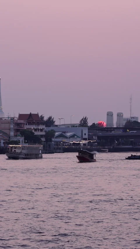 Dusk from the chao phraya river where the illuminated boats circulate near the Stock Footage 279347858