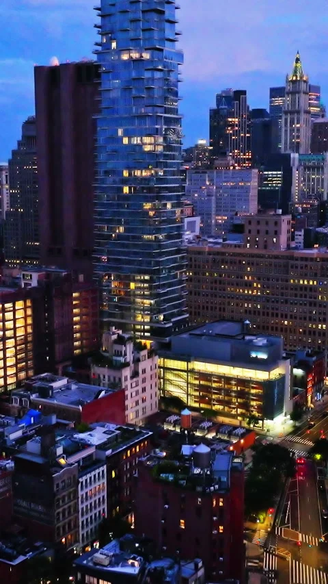 Dusk cityscape with staggered skyscraper and traffic trails. Vertical video. 스톡 동영상 321348934