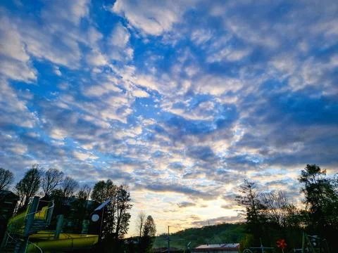 A Dusk Cloudscape Surrounded by Abundant Lush, Vibrant Greenery in Nature Stock Photos