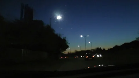 Dusk driving on Ringroad stop at roundabout 動画素材 104311521