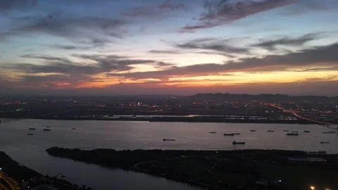 Dusk drone view of bridge towers and river skyline lights in China Stock Footage 337759676