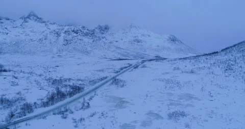Dusk empty winter road over ice snowy mountain pass in Arctic Stock Footage 149942594