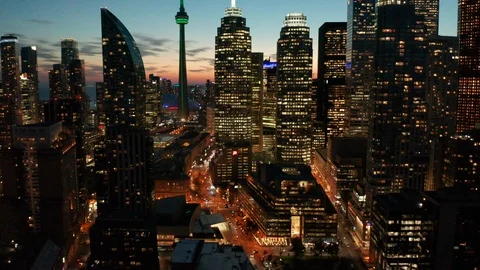 Dusk flying forward and tilting up on Toronto skyline Stock Footage 96324516