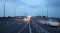 Dusk highway road city traffic, car drive lights on, sky HD Footage