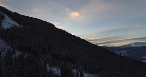 Dusk lighting overlooking tree covered mountain in Austrian Alps Stock Footage 102488829
