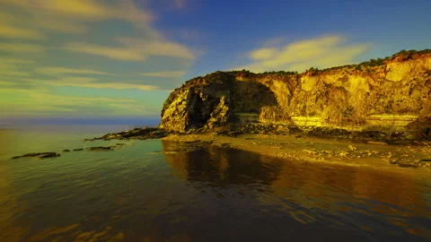 Dusk over rugged shoreline. Dark clouds cast shadows on coastal rocks Stock Footage 339792230