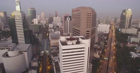 Dusk Over Silom District in Downtown Bangkok, Aerial Drone Shot Stock Footage 71669062