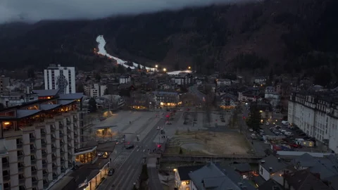 Dusk settles over Chamonix town center nestled in the French Alps, lights Video stock 317293166