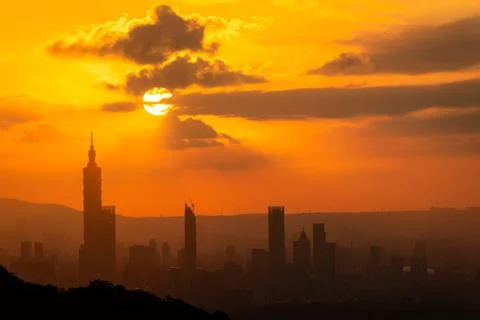 At dusk, the sun breaks through the clouds and shines on Taipei City. Stock Photos