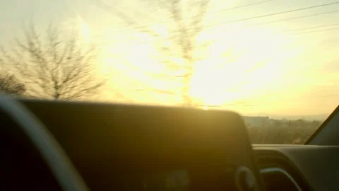 Dusk sunlight streams through vehicle window casting warm reflections Видео 334118424