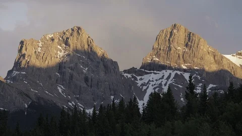 Dusk time lapse behind two of the Three Sisters in Alberta Stock Footage 90833971