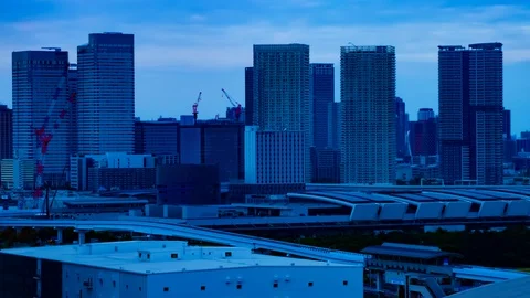 A dusk timelapse of the cityscape at the urban street in Ariake Tokyo long shot Stock Footage