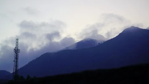 Dusk timelapse of mountain with clouds and a cell communication tower Stock Footage 124997290