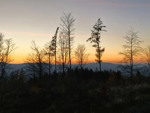 Dusk view showing distant hills and trees, vivid sunset over rolling hills with Stock Photos