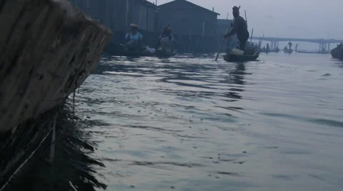 Dusk water level shot, reflections, canoes Makoko Stock Footage 38483006