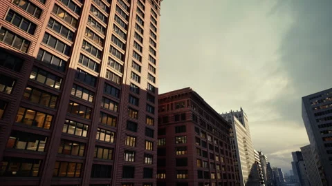Dusklit office tower with glowing internal lights and historic surroundings Stock Footage 334341997