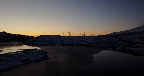 Dusk's Harmony: Wintry Sunset and Wind Turbines in Norway Video stock 264760674